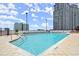 Outdoor pool with lounge chairs and city views on a sunny day at 3324 Peachtree Ne Rd # 1407, Atlanta, GA 30326