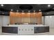 Close up of the modern reception desk featuring a light wood facade and dark gray desk with modern lighting at 3324 Peachtree Ne Rd # 1407, Atlanta, GA 30326