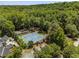 Aerial shot featuring tennis courts nestled within a wooded area, offering recreational opportunities at 3848 Saint Annes Ct, Duluth, GA 30096