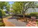 The home has a landscaped yard with gravel, brickwork and small fountain at 3848 Saint Annes Ct, Duluth, GA 30096