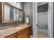 Bathroom featuring granite countertops, a vanity with a large mirror and a shower/tub combo at 3848 Saint Annes Ct, Duluth, GA 30096