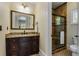 Bathroom featuring granite countertop vanity, tile shower, and framed mirror at 3848 Saint Annes Ct, Duluth, GA 30096