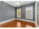 Bedroom with gray walls, wood floors, two windows and white trim at 3848 Saint Annes Ct, Duluth, GA 30096