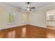 Bedroom with hardwood floors, natural light from shuttered windows, and an ensuite bathroom at 3848 Saint Annes Ct, Duluth, GA 30096