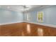 Bedroom featuring light blue walls, hardwood flooring, white trim and two windows at 3848 Saint Annes Ct, Duluth, GA 30096