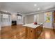 The kitchen has a center island and flows into a living area with built-ins and a fireplace at 3848 Saint Annes Ct, Duluth, GA 30096