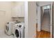 Laundry room featuring side by side washer and dryer, utility sink, and white cabinets at 3848 Saint Annes Ct, Duluth, GA 30096