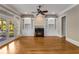 Bright living room with hardwood floors, fireplace, built-in bookshelves and access to outdoor deck at 3848 Saint Annes Ct, Duluth, GA 30096