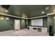 Finished media room featuring carpet, recessed lighting, and a projection screen at 3848 Saint Annes Ct, Duluth, GA 30096