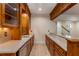 Wet bar featuring custom cabinets, stone countertop, utility sink, and mini refrigerator at 3848 Saint Annes Ct, Duluth, GA 30096