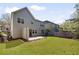 Home's backyard showing a well-manicured lawn, and flower beds bordering the patio at 516 Winder Trl, Canton, GA 30114