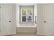 Bathroom featuring soaking tub, tile floor and two doors at 516 Winder Trl, Canton, GA 30114