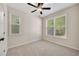 Cozy bedroom filled with natural light from two large windows and plush carpet at 516 Winder Trl, Canton, GA 30114
