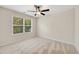 Bedroom featuring neutral paint, carpet, fan and a large window with views of lush greenery at 516 Winder Trl, Canton, GA 30114