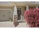 Inviting front porch with stone columns, house number, and colorful landscaping at 516 Winder Trl, Canton, GA 30114