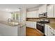 Stylish kitchen features stainless steel appliances, granite countertops, and hardwood floors at 516 Winder Trl, Canton, GA 30114