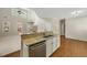 Well-lit kitchen opens to living area and boasts modern appliances and granite countertop island at 516 Winder Trl, Canton, GA 30114