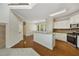 Kitchen with stainless steel appliances, breakfast bar, and hardwood floors at 516 Winder Trl, Canton, GA 30114