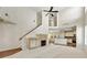 Living room with tall ceilings, wood floors, fireplace, and view of the kitchen at 516 Winder Trl, Canton, GA 30114