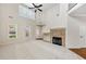 Bright living room featuring a fireplace, large windows, and soaring ceilings, perfect for entertaining at 516 Winder Trl, Canton, GA 30114