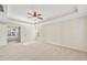 Spacious main bedroom featuring carpeted floors, tray ceilings, neutral walls, and attached sitting room with tub at 516 Winder Trl, Canton, GA 30114