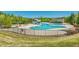 A community pool with waterslide, a kid pool, a covered lounge area, and a black metal fence at 516 Winder Trl, Canton, GA 30114