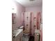 Bright bathroom with pink accents featuring a decorative shower curtain and white fixtures at 636 North Ave # H-10, Jonesboro, GA 30236