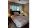 Cozy bedroom with a decorative headboard and matching floral patterned quilt at 636 North Ave # H-10, Jonesboro, GA 30236