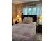 Comfortable bedroom with a built-in headboard and charming bedside lamps at 636 North Ave # H-10, Jonesboro, GA 30236