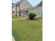 Townhome showcasing a well-maintained lawn, brick accents and patio furniture at 636 North Ave # H-10, Jonesboro, GA 30236