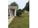 Charming townhome featuring well-manicured landscaping, flower beds, and a covered porch at 636 North Ave # H-10, Jonesboro, GA 30236