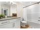 Bright bathroom featuring granite counters, white cabinets, and a shower-tub combo at 212 Starr Cir, Stockbridge, GA 30281