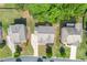 Overhead view of homes, green lawns, and tree-lined streets at 325 Cranbrooke Cir, Suwanee, GA 30024