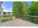 Wooden deck offering a view of the lush, green backyard and mature trees at 325 Cranbrooke Cir, Suwanee, GA 30024