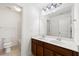 Bathroom boasts double sinks, wooden cabinetry, and a well-lit vanity mirror at 325 Cranbrooke Cir, Suwanee, GA 30024