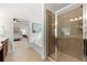 Spacious bathroom featuring tile shower, soaking tub, and access to the main bedroom at 325 Cranbrooke Cir, Suwanee, GA 30024