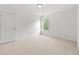 This bright bedroom features neutral carpeting and a window for natural light at 325 Cranbrooke Cir, Suwanee, GA 30024
