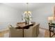 Stylish dining area with a modern chandelier and seating for six at 325 Cranbrooke Cir, Suwanee, GA 30024