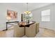 Elegant dining room with stylish chandelier, modern art, and seating for six at 325 Cranbrooke Cir, Suwanee, GA 30024