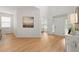 Bright entryway with hardwood floors, natural light, and view into the dining area at 325 Cranbrooke Cir, Suwanee, GA 30024
