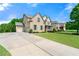 Beautiful home featuring a manicured lawn and driveway at 325 Cranbrooke Cir, Suwanee, GA 30024