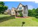 Charming two-story home with manicured lawn and a brick-lined garden bed at 325 Cranbrooke Cir, Suwanee, GA 30024
