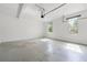Spacious two-car garage featuring a concrete floor and natural light at 325 Cranbrooke Cir, Suwanee, GA 30024