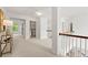 Bright hallway boasts neutral carpet, white walls, and a laundry closet for added convenience at 325 Cranbrooke Cir, Suwanee, GA 30024