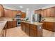 Beautiful kitchen with granite island, wood cabinets, and stainless steel appliances at 325 Cranbrooke Cir, Suwanee, GA 30024