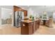 Well-equipped kitchen with stainless steel appliances, a granite island, and dark wood cabinetry at 325 Cranbrooke Cir, Suwanee, GA 30024