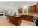 Modern kitchen with a large center island, stainless appliances, and a gas range at 325 Cranbrooke Cir, Suwanee, GA 30024