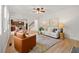 Open-concept living room with hardwood floors, ceiling fan, and neutral decor at 325 Cranbrooke Cir, Suwanee, GA 30024