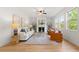 Bright living room with large windows, fireplace, and neutral decor at 325 Cranbrooke Cir, Suwanee, GA 30024