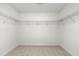 Walk-in closet with carpet and wire shelving ready for easy organization at 325 Cranbrooke Cir, Suwanee, GA 30024